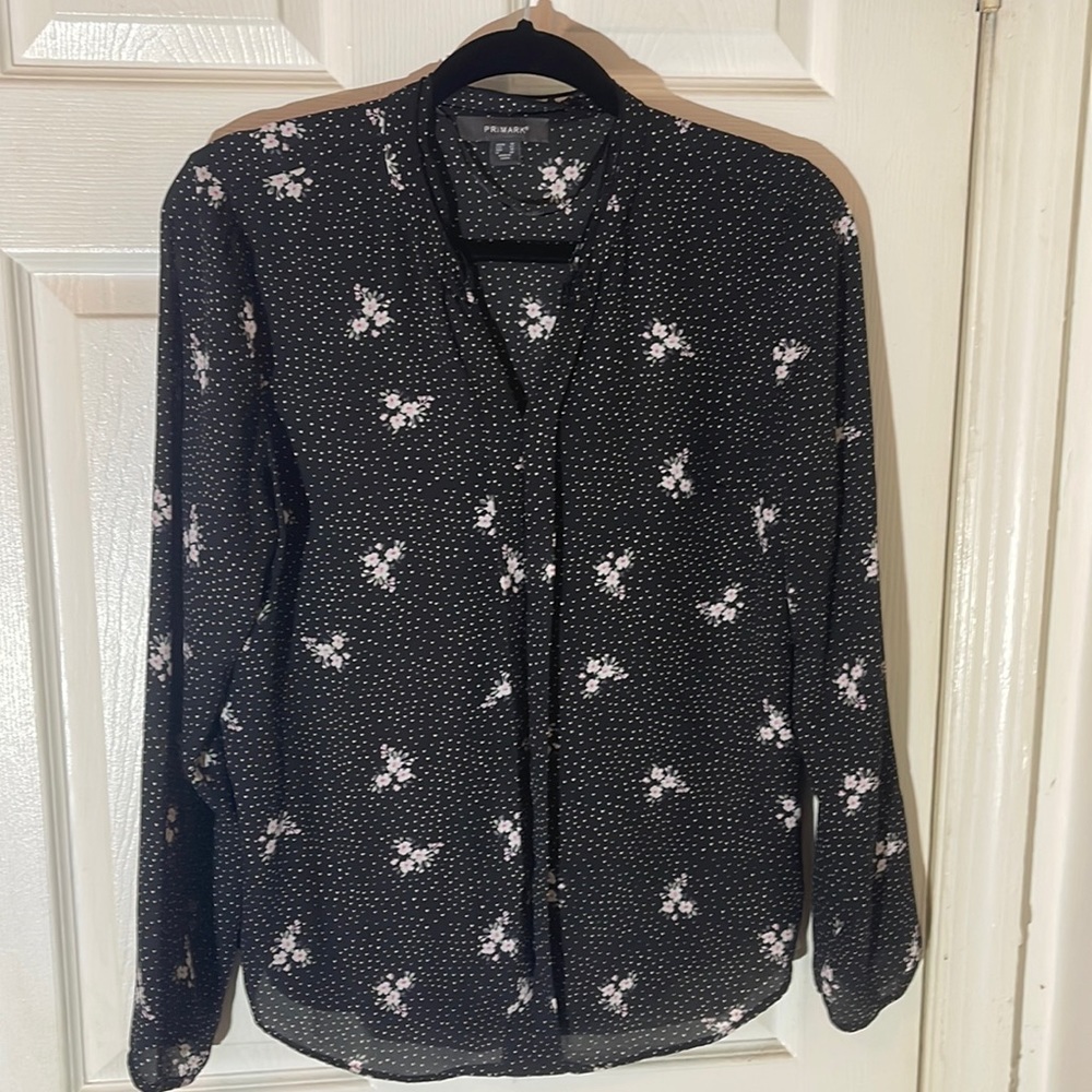 Women’s blouse black w/floral designs throughout. Size: 10